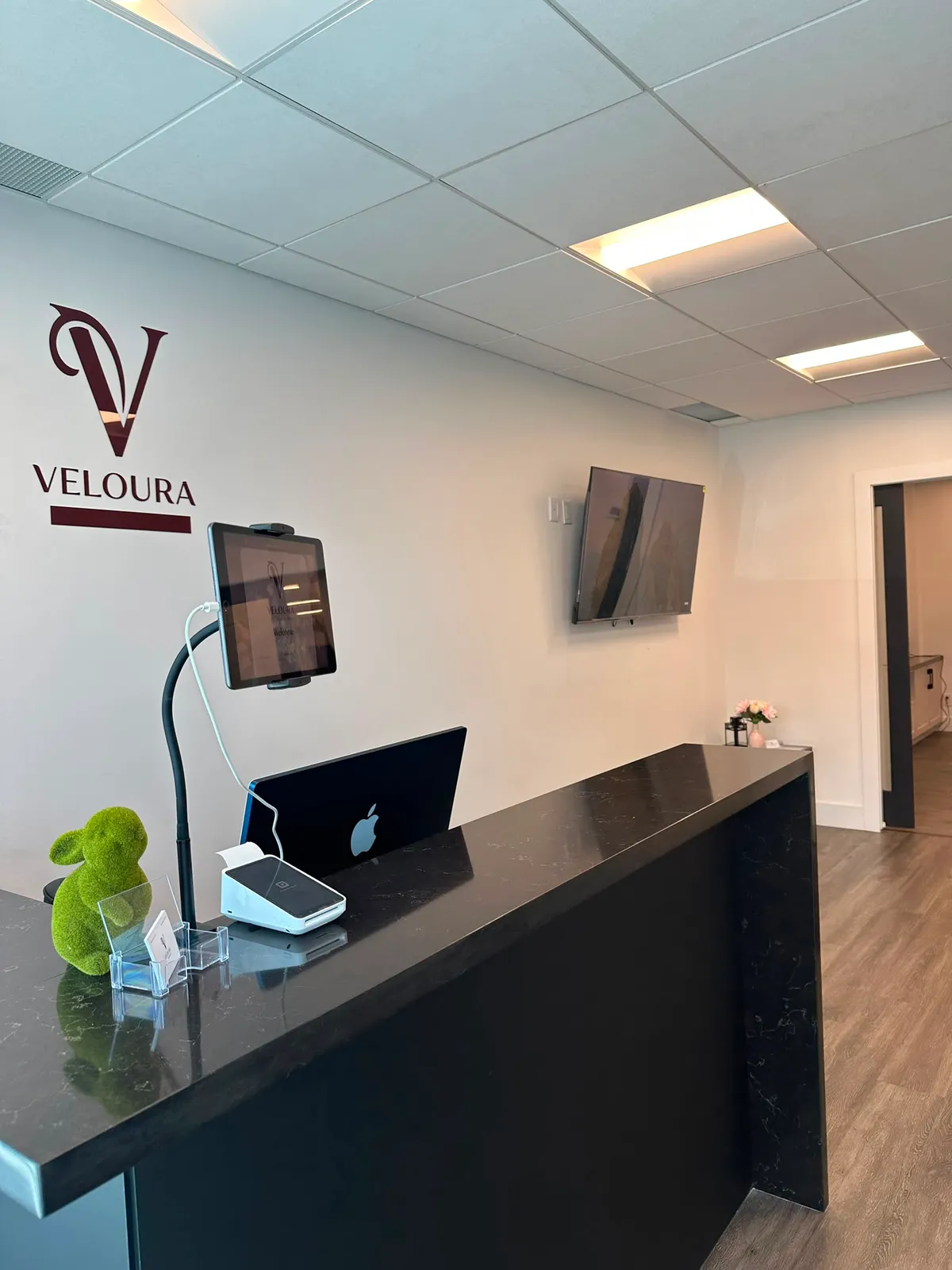 Front desk at Veloura SugarWax Bar Woodbridge with check-in tablet